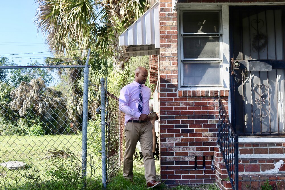 Dr. Albert Chester pictured above helping a customer of New Town Pharmacy &amp; below delivering medication to a patient ‘s home